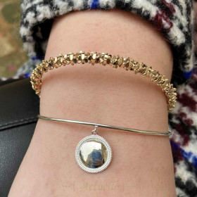 Open bangle with medallion pendant